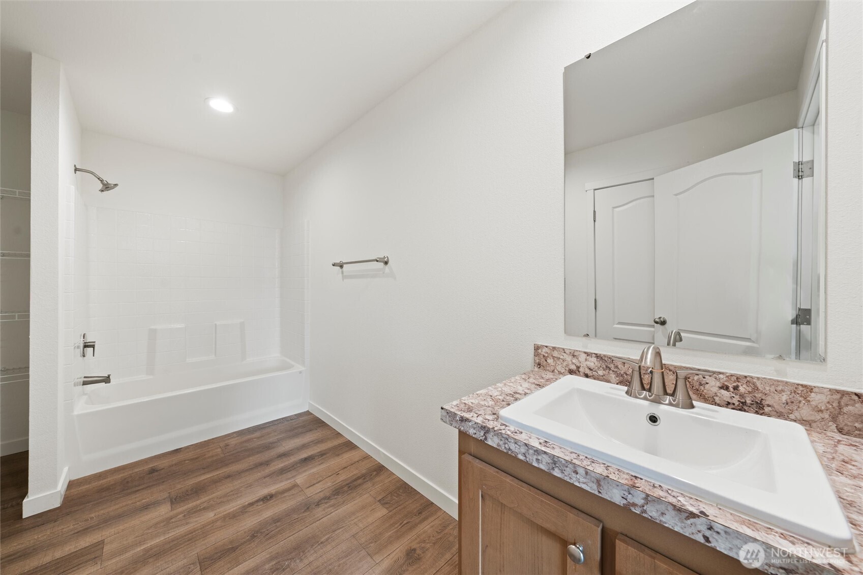 1701 Burr Avenue, Unit 51 Moses Lake, WA 98837 - Photo 32 of 35 a bathroom with a granite countertop sink and a mirror