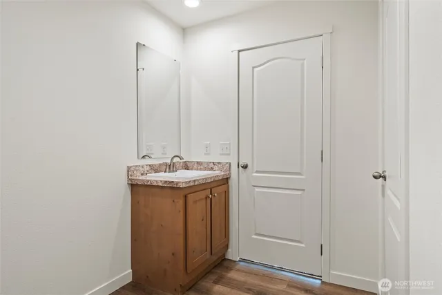 a bathroom with a granite countertop sink and a mirror