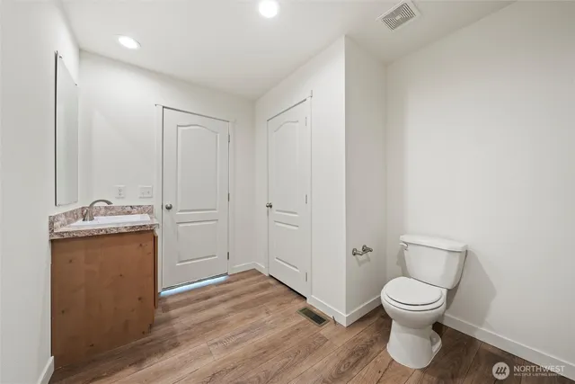 a view of bathroom with a toilet sink and a mirror