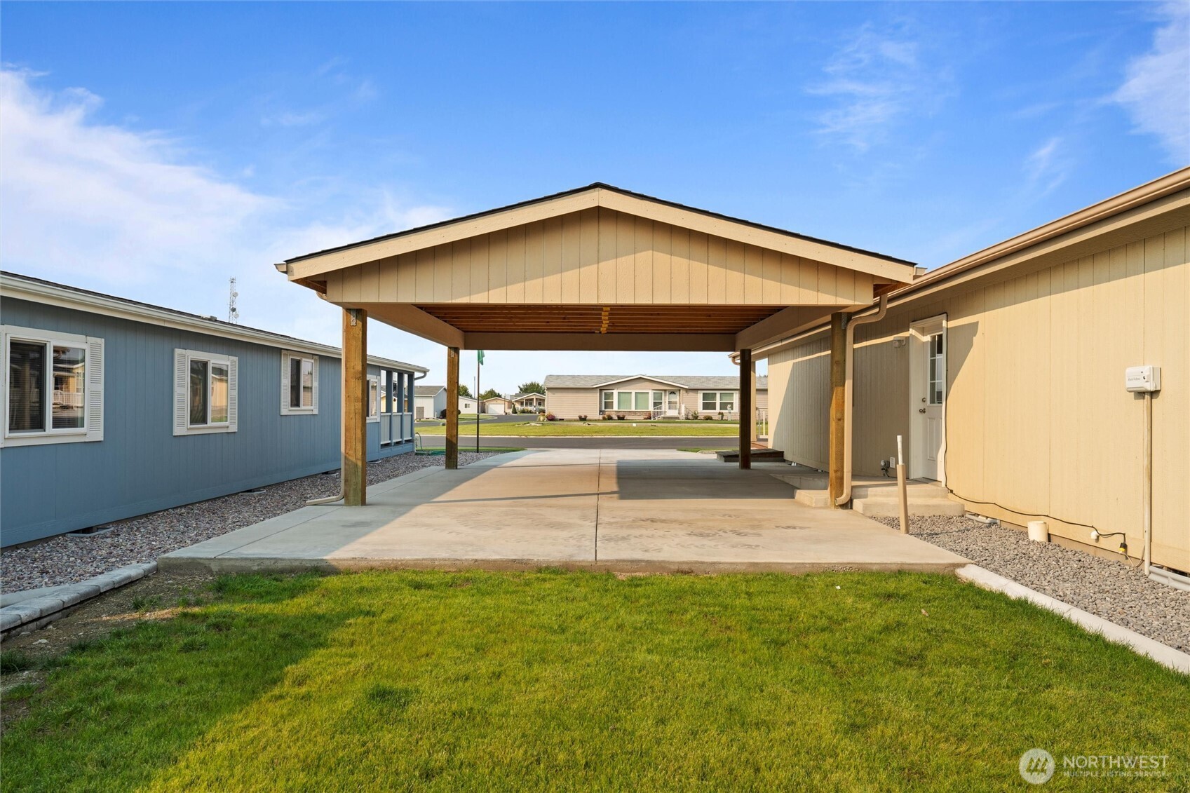 1701 Burr Avenue, Unit 51 Moses Lake, WA 98837 - Photo 5 of 35 a view of a backyard with a garden and deck
