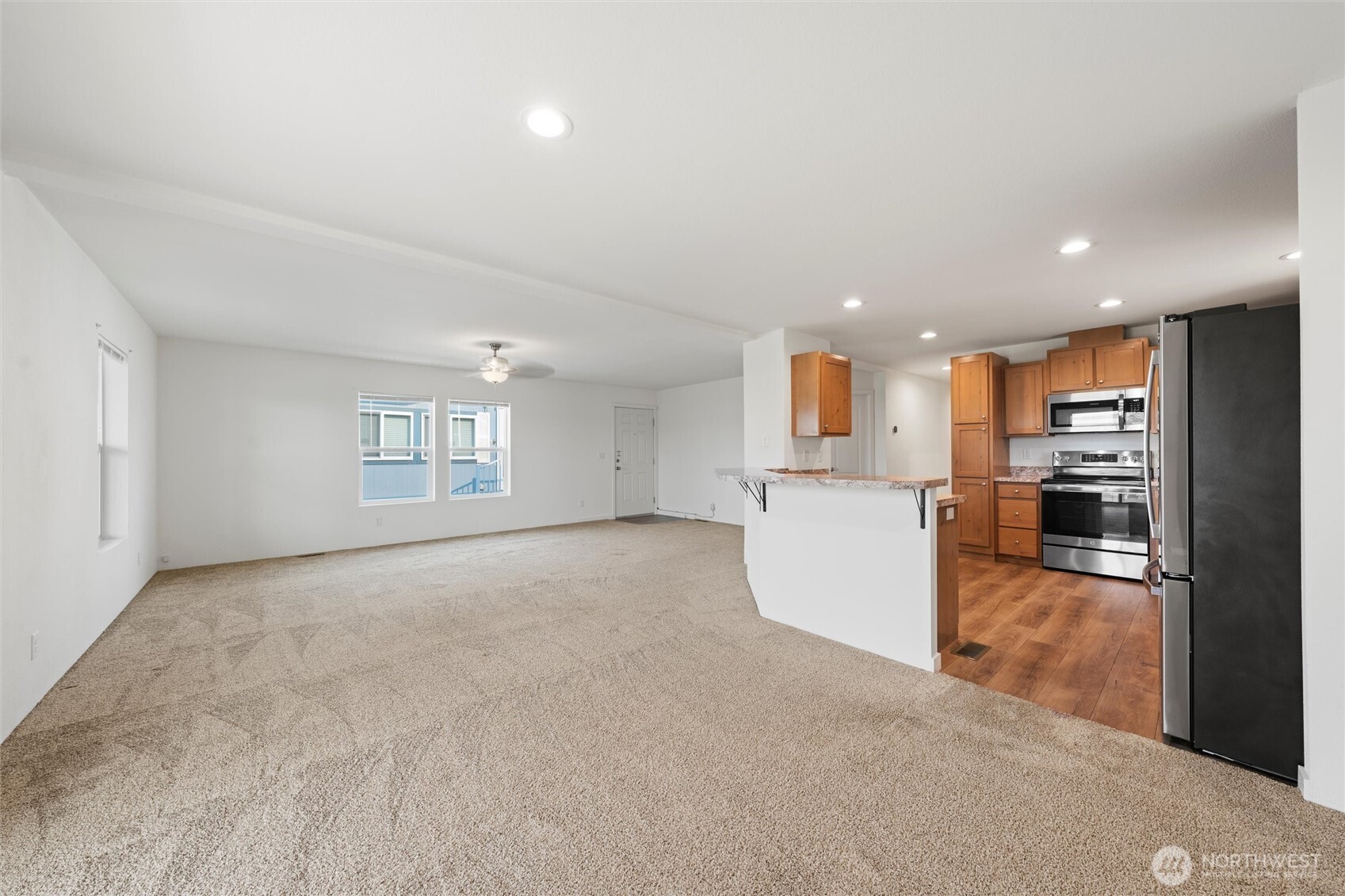 1701 Burr Avenue, Unit 51 Moses Lake, WA 98837 - Photo 8 of 35 an empty room with kitchen appliances and windows