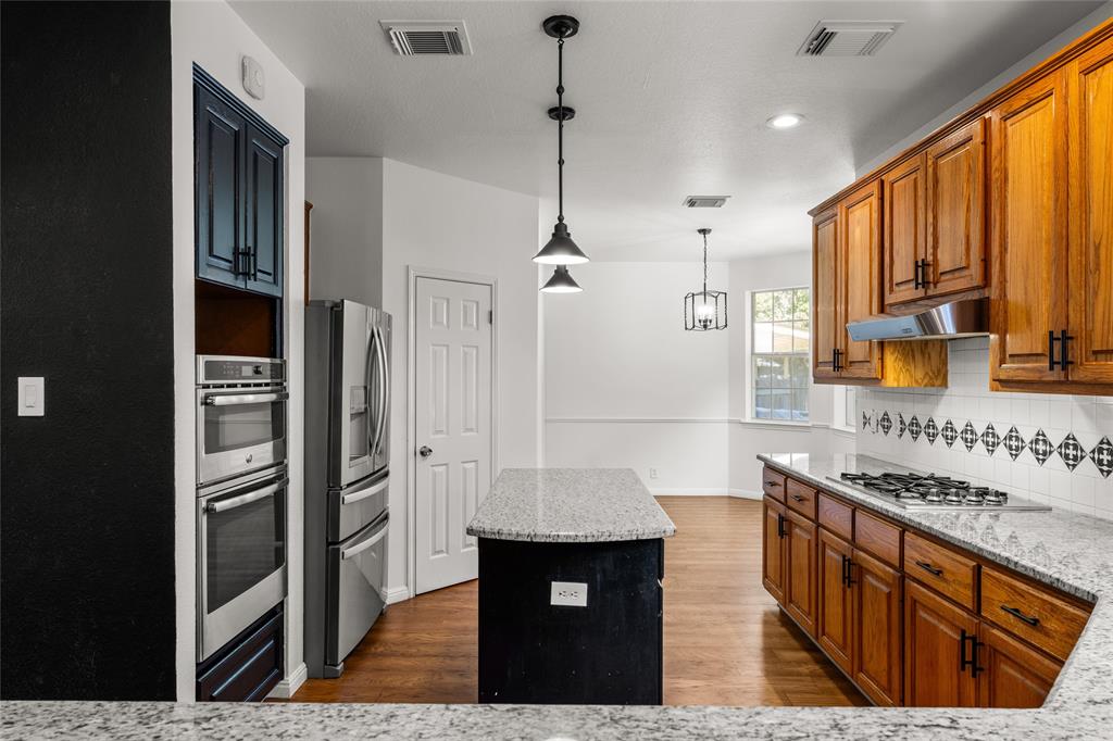 3901 Caney Creek Road Austin, TX 78732 - Photo 6 of 18 Breakfast dining off of the kitchen. Granite counters and tile backsplash.