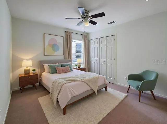 a bedroom with a bed and a chandelier