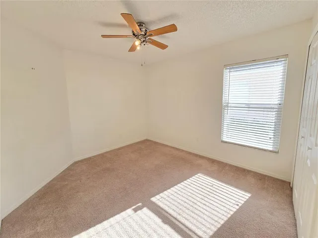 a view of a big room with wooden floor and a window