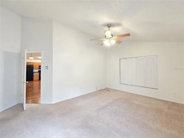 an empty room with fan and a ceiling fan