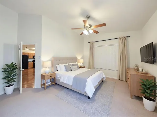 a bedroom with a large bed and a chandelier