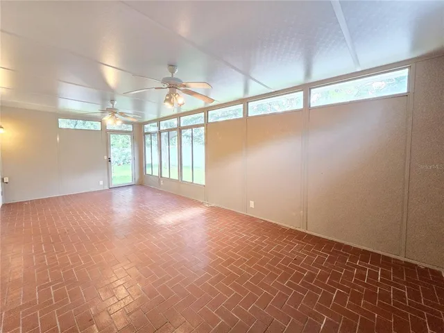 an empty room with windows and entrance