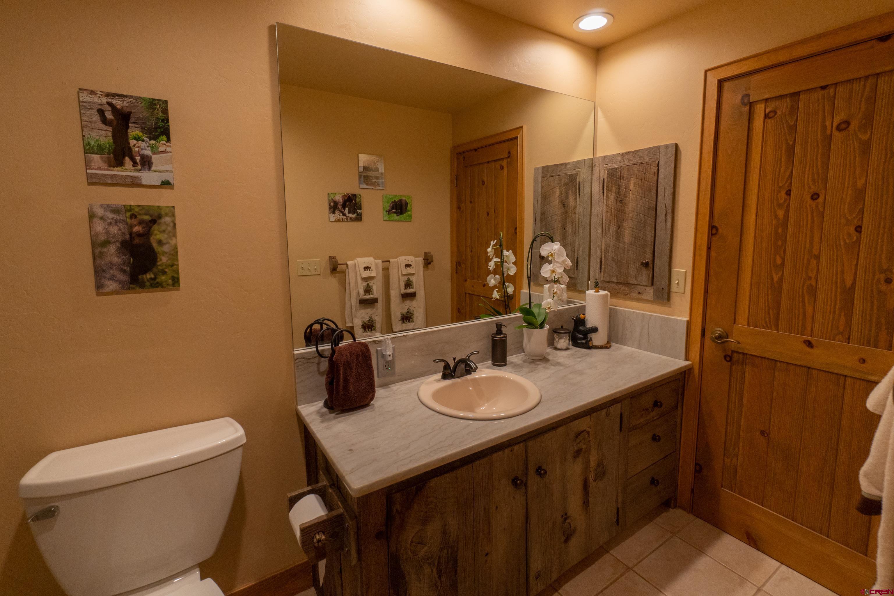 104 River Run Durango, CO 81301 - Photo 15 of 34 a bathroom with a granite countertop sink a toilet and shower