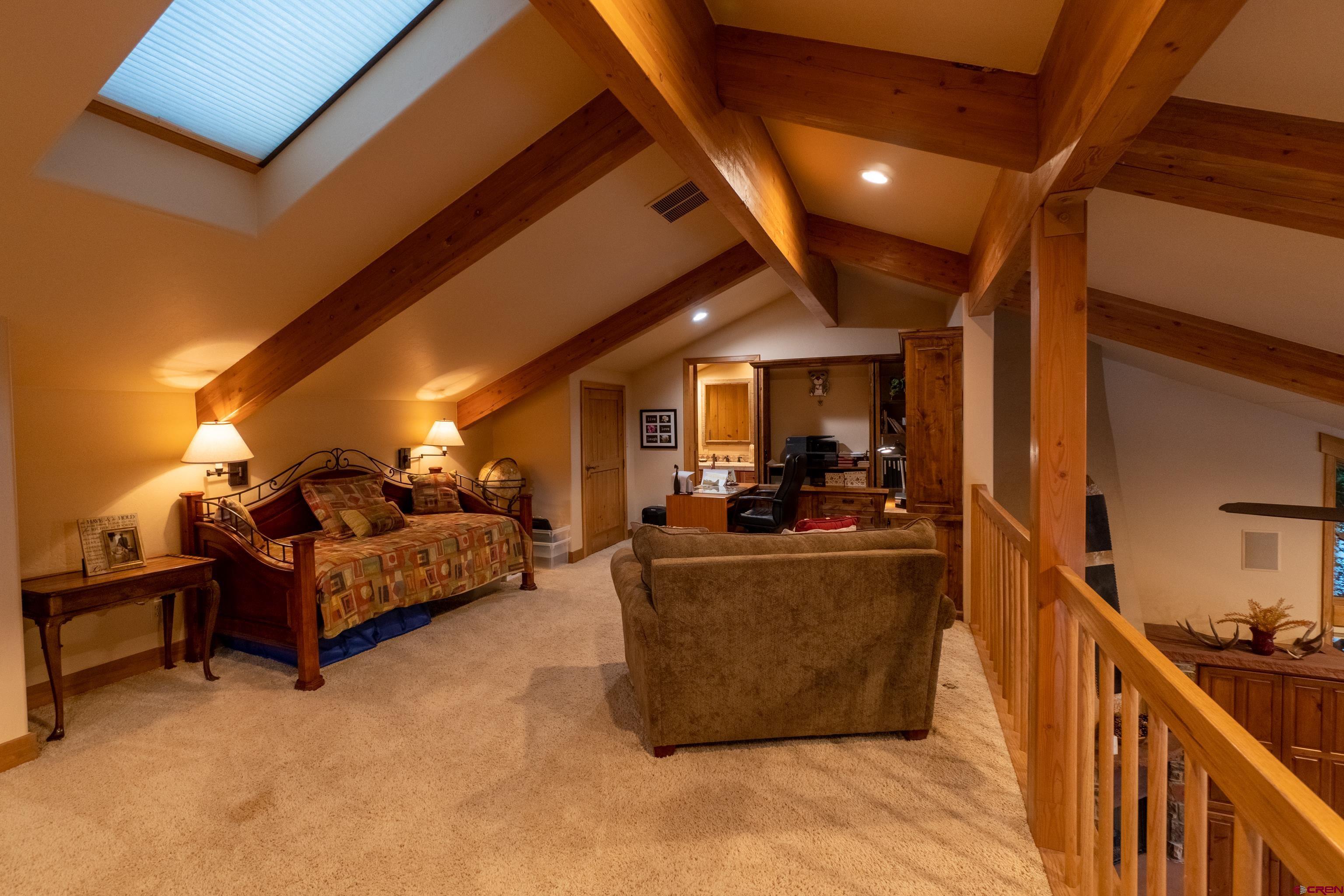 104 River Run Durango, CO 81301 - Photo 22 of 34 a living room with furniture a chandelier and a fireplace