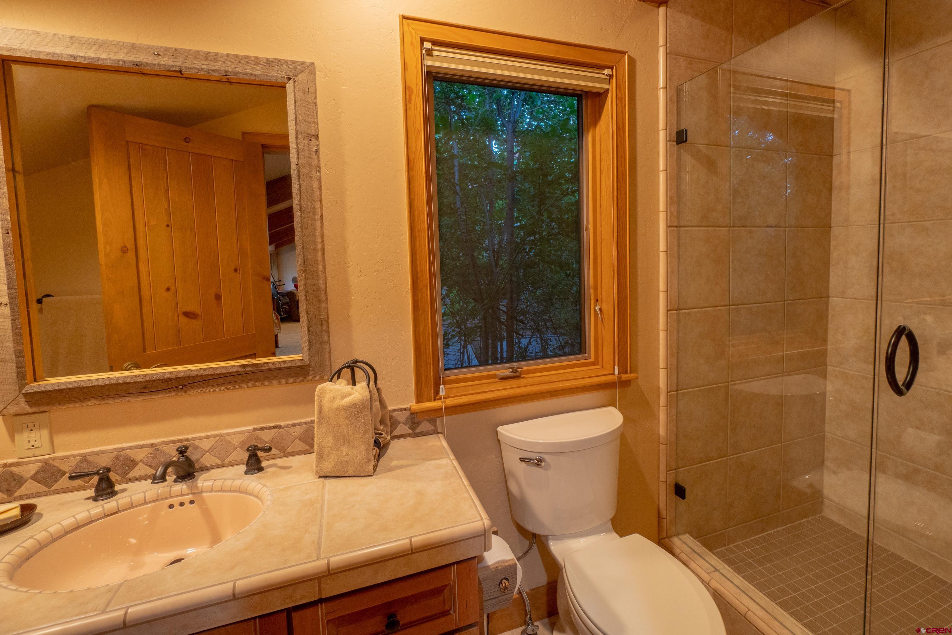 104 River Run Durango, CO 81301 - Photo 24 of 34 a bathroom with a sink a toilet and shower
