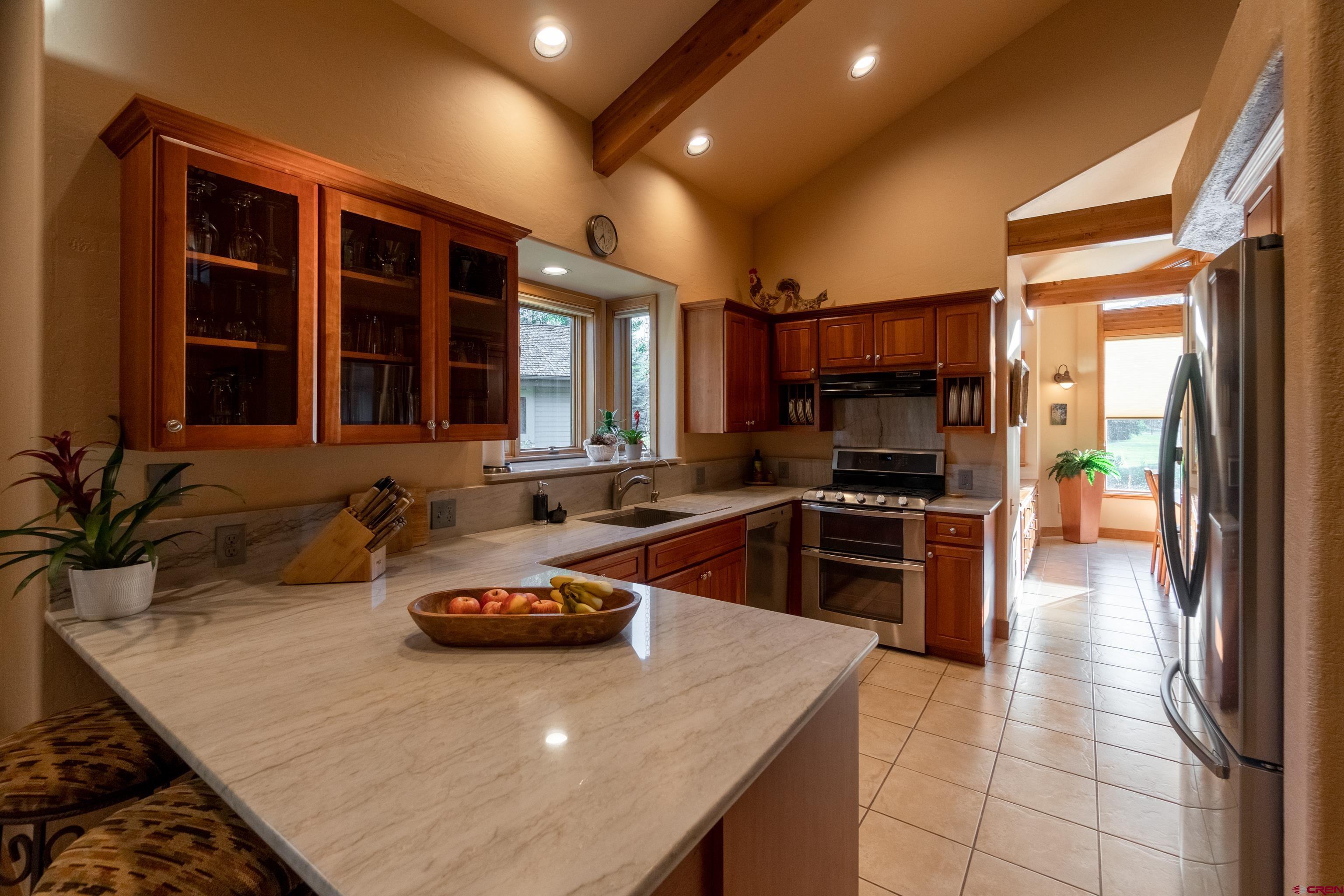 104 River Run Durango, CO 81301 - Photo 6 of 34 a kitchen with a sink a stove and cabinets