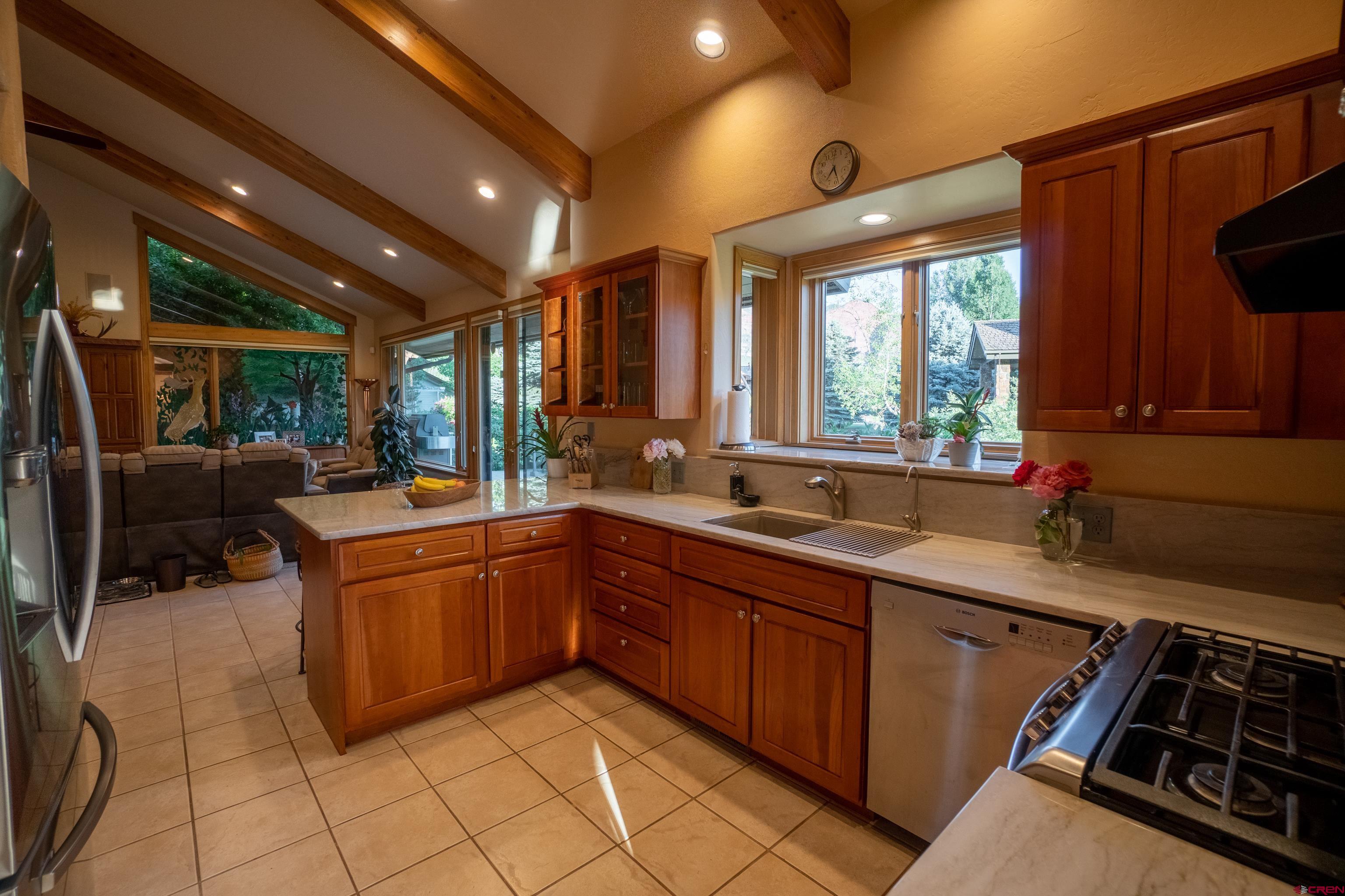 104 River Run Durango, CO 81301 - Photo 8 of 34 a kitchen with stainless steel appliances granite countertop a sink and cabinets