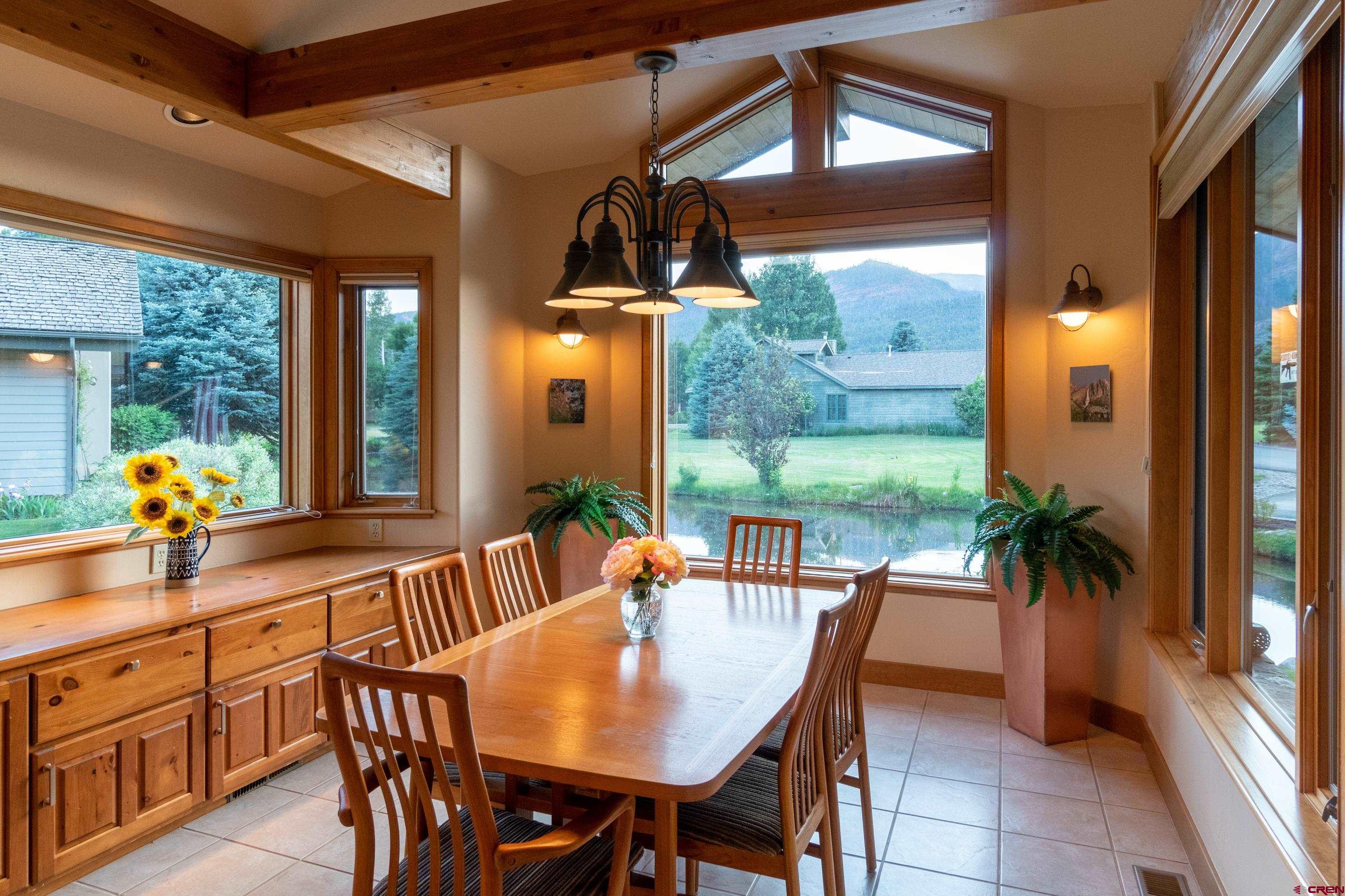 104 River Run Durango, CO 81301 - Photo 9 of 34 a dining room with furniture a potted plant and a large window