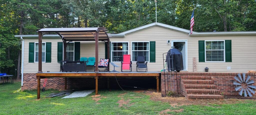 3171 Neals Corner Road Clover, VA 24534 - Photo 1 of 6 a view of a house with a backyard and a patio