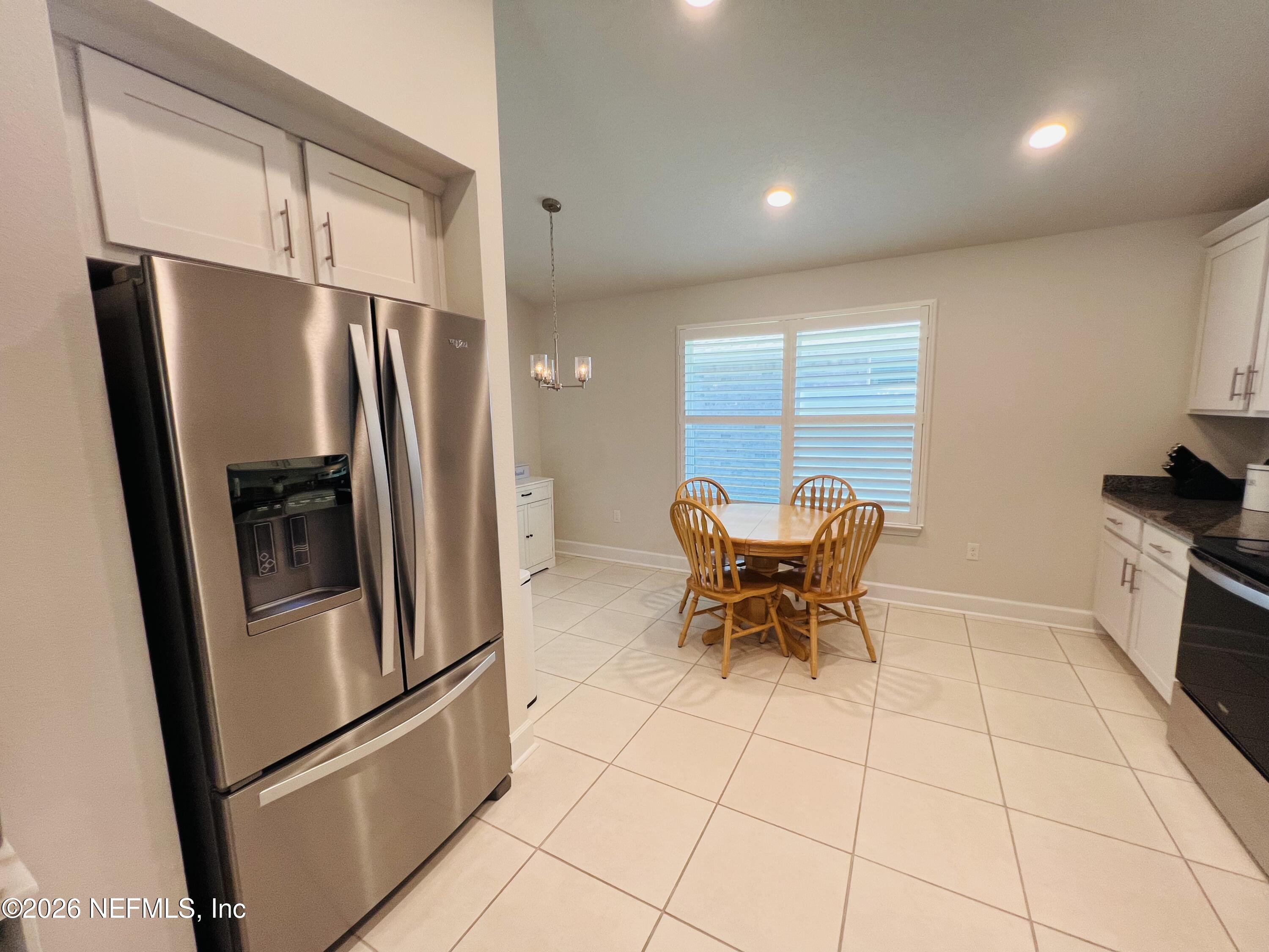 2 Rivertown Road Palm Coast, FL 32137 - Photo 41 of 80 a kitchen with stainless steel appliances granite countertop a refrigerator and a stove top oven