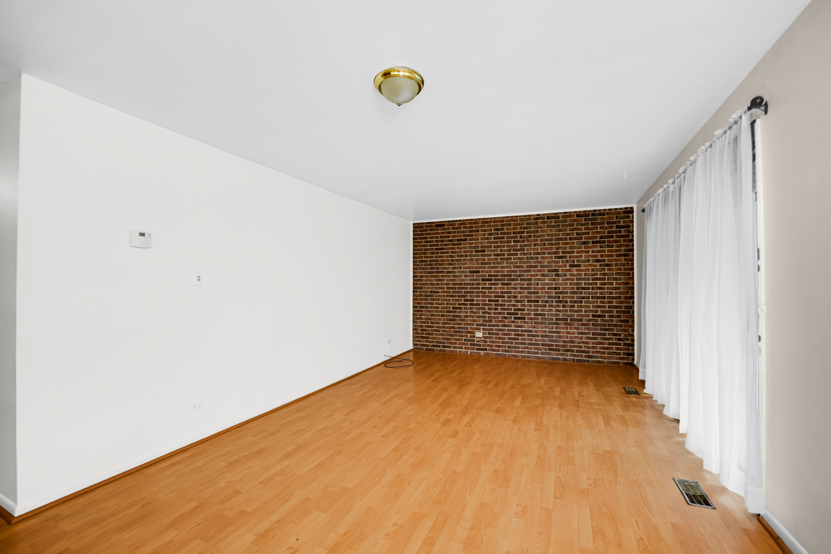 1100 Holbrook Road, Unit D Homewood, IL 60430 - Photo 5 of 16 a view of an empty room with wooden floor
