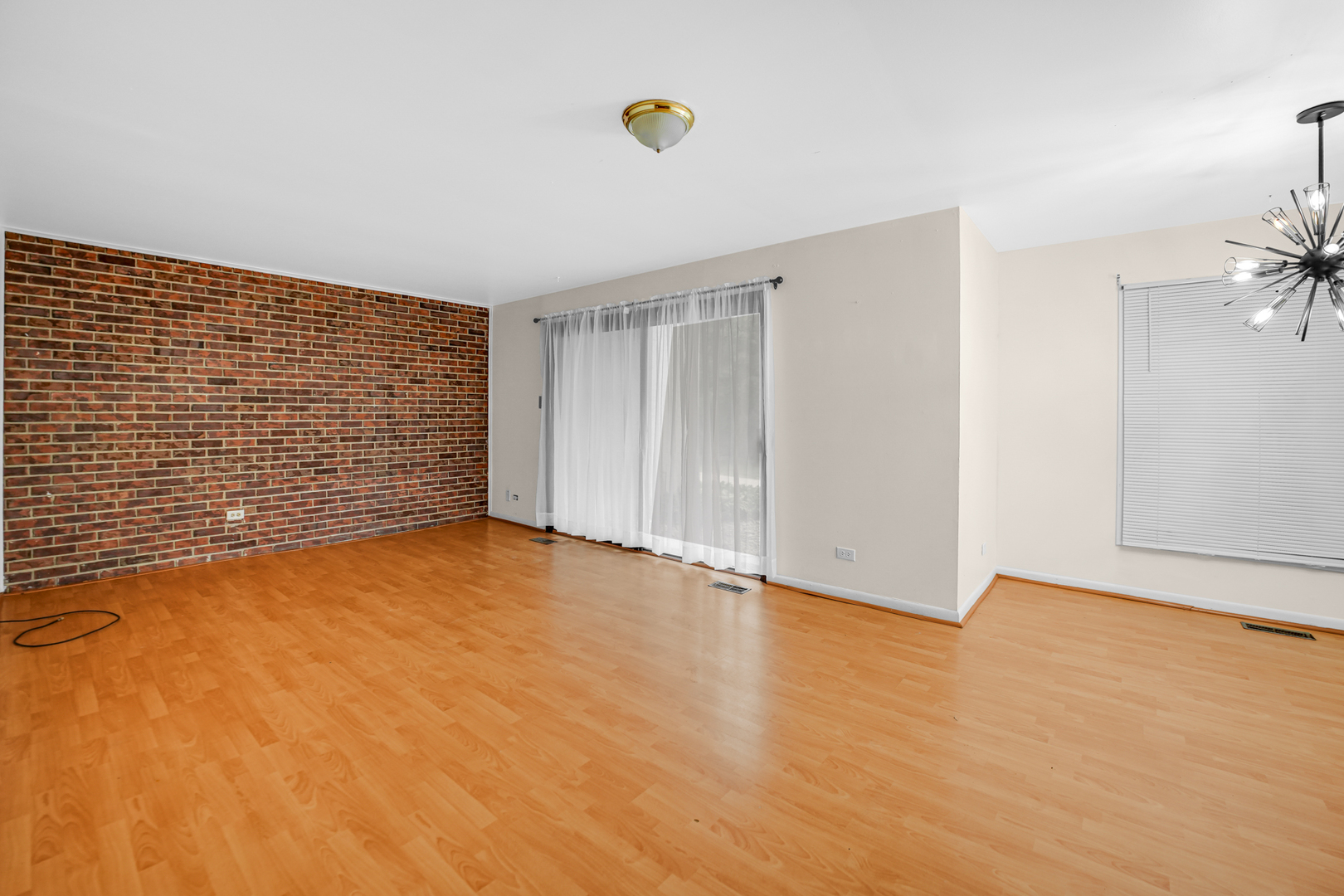 1100 Holbrook Road, Unit D Homewood, IL 60430 - Photo 6 of 16 a view of an empty room with wooden floor and fan