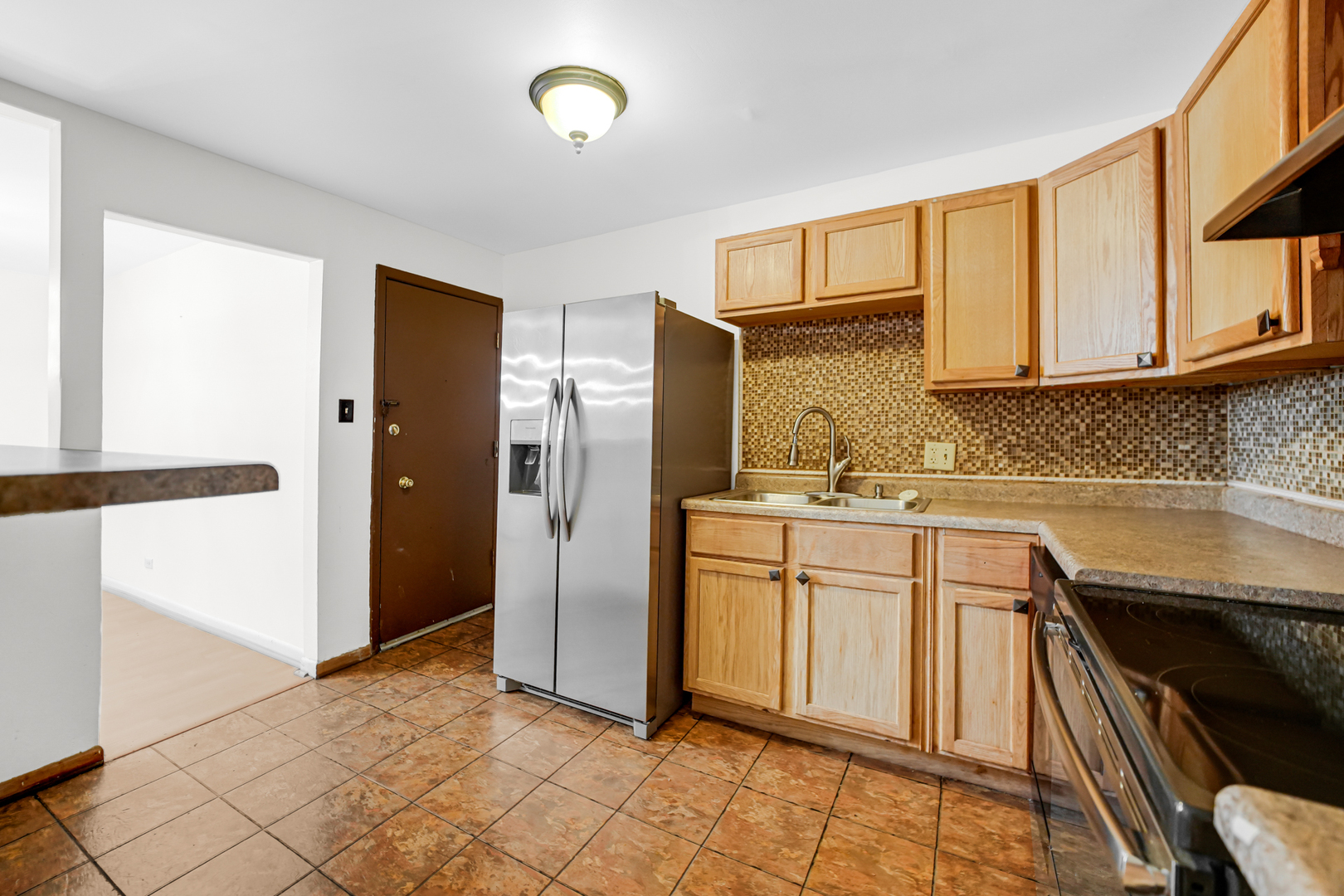 1100 Holbrook Road, Unit D Homewood, IL 60430 - Photo 7 of 16 a kitchen with granite countertop a refrigerator and a sink