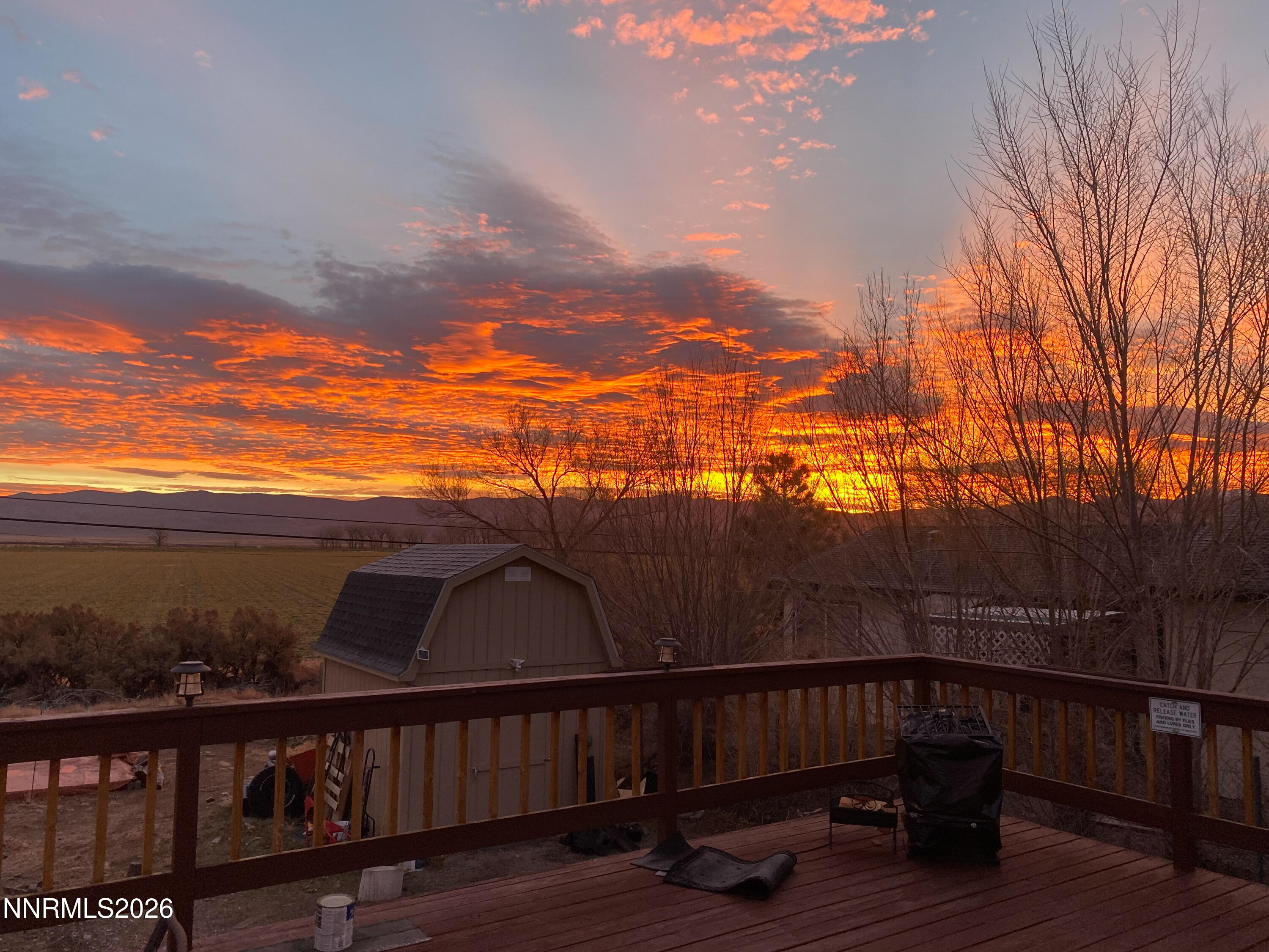 a view of a roof deck with wooden floor and fence