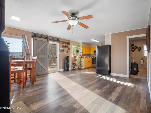 a view of a livingroom with furniture and hardwood floor