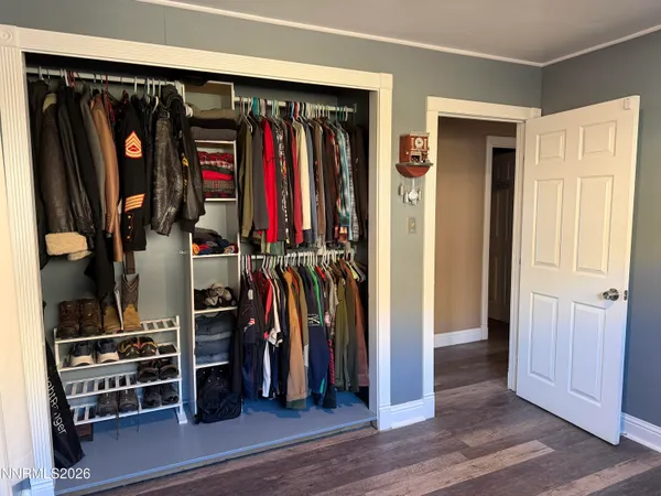 a view of walk in closet with clothes and shoes