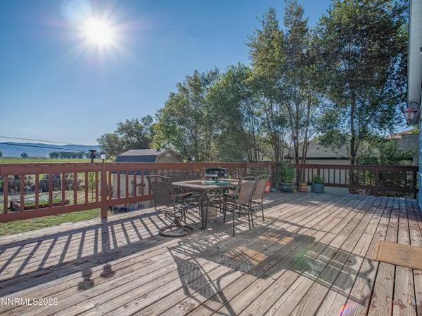 a view of a patio with table and chairs and wooden floor