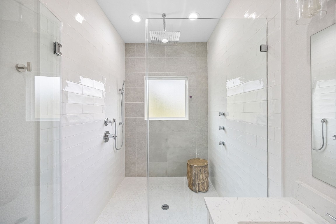 317 Sikes Street Houston, TX 77018 - Photo 22 of 30 Fabulous walk-in shower, complete with a refreshing rain shower head and the invigorating experience of three strategically placed body jets, promising a spa-like experience.