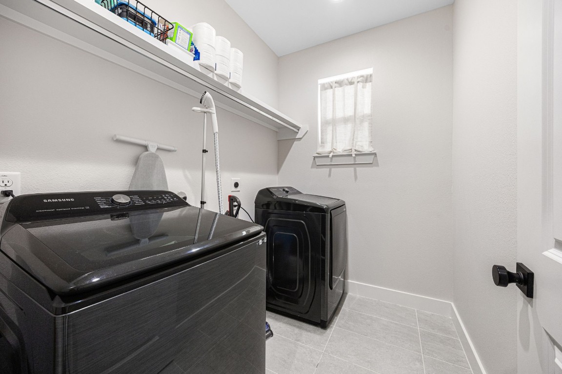 317 Sikes Street Houston, TX 77018 - Photo 27 of 30 Convenient second-floor laundry features include a shelf and rod for hanging clothes. The Samsung washer and dryer are included!