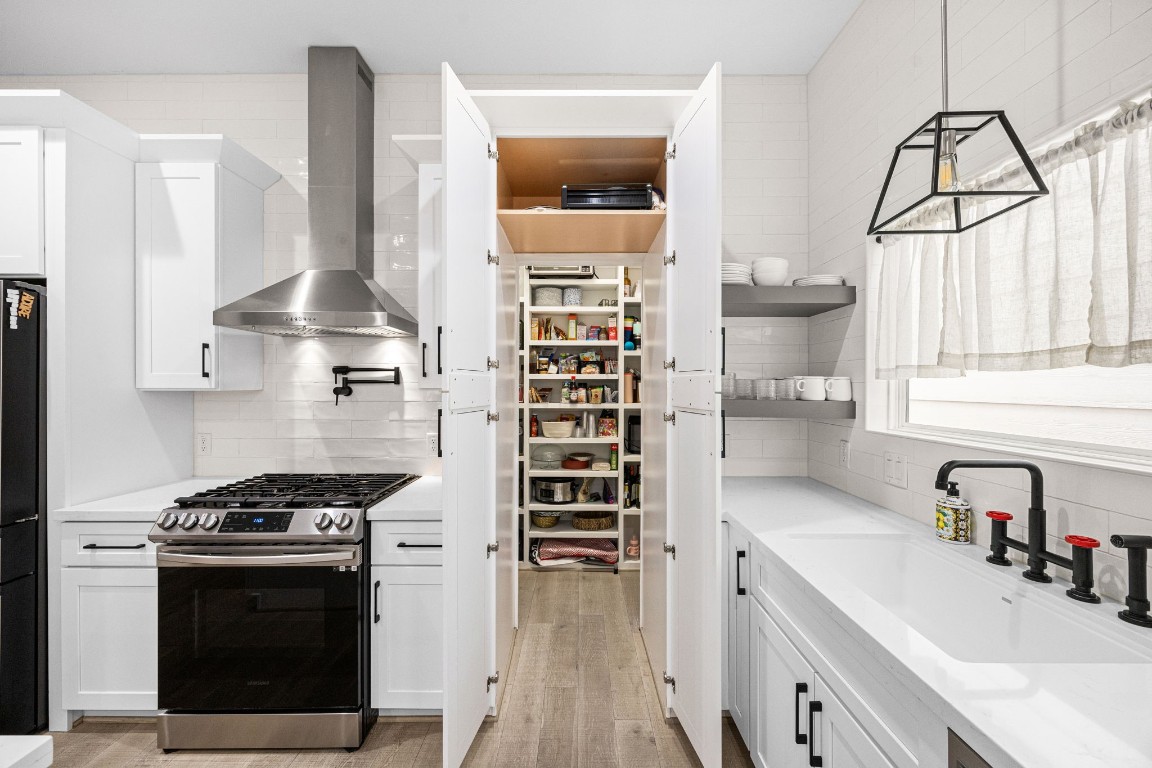 317 Sikes Street Houston, TX 77018 - Photo 6 of 30 Hidden walk-in pantry revealed! Discreetly concealed behind cabinet doors for a clean look, opening to a spacious and highly organized storage haven.