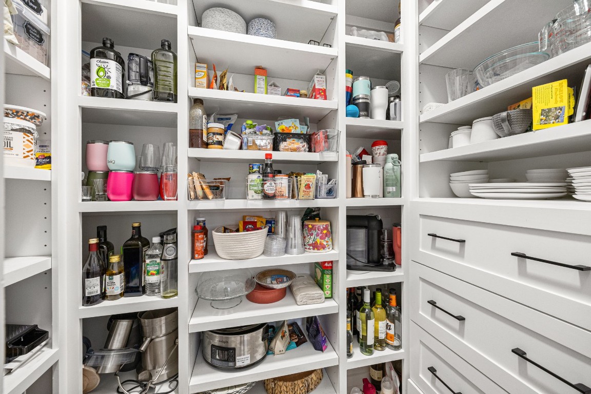 317 Sikes Street Houston, TX 77018 - Photo 7 of 30 Spacious secret walk-in pantry boasting custom adjustable shelving throughout – perfectly configured to stock your dry goods, appliances, dishes, tumblers, spices, and plenty of room to customize further.