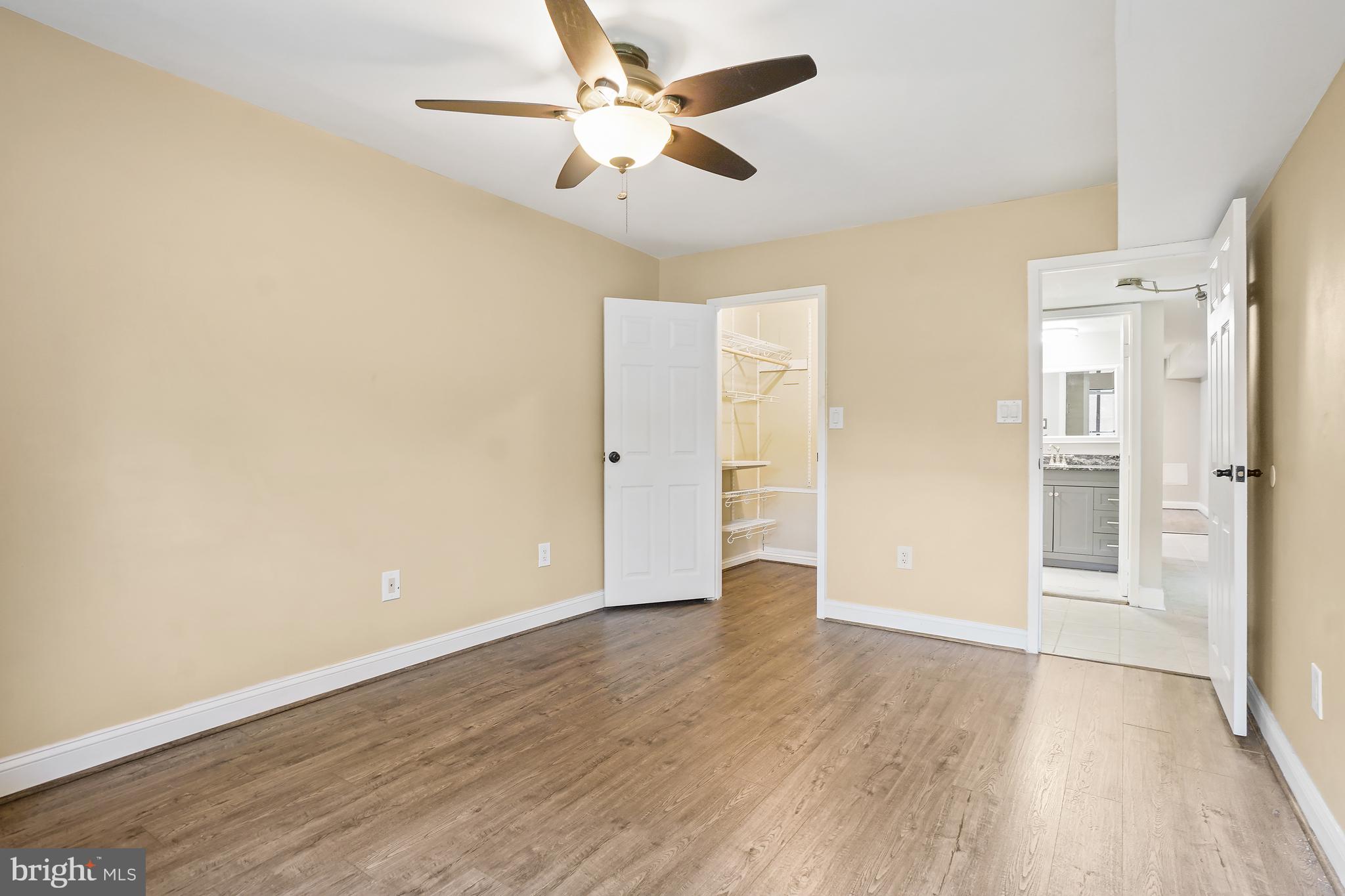 8487 Greenbelt Road Greenbelt, MD 20770 - Photo 21 of 29 an empty room with wooden floor and ceiling fan