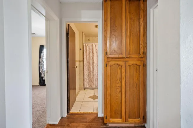 a kitchen with white cabinets and window