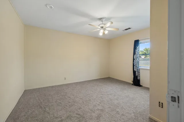a view of a dining room with furniture and a chandelier