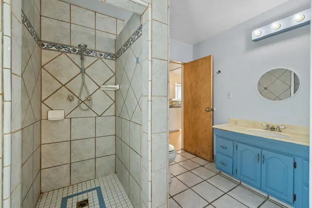a view of a backyard with table and chairs under a large umbrella