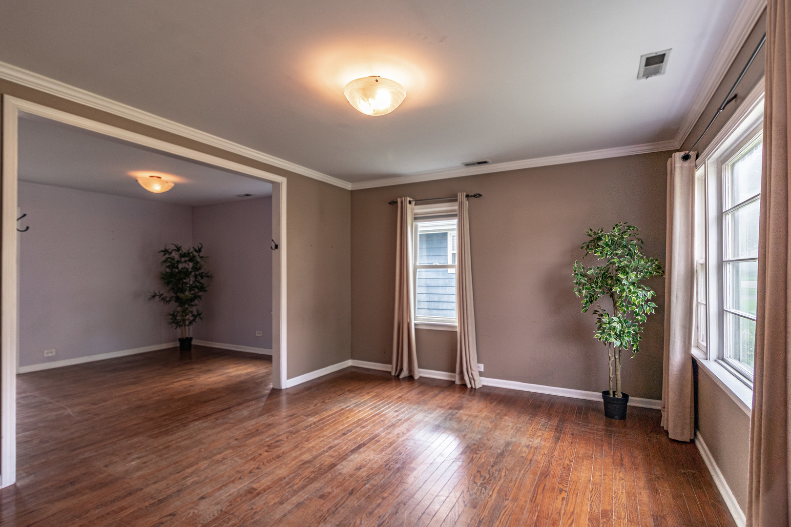 18229 West Big Oaks Road Grayslake, IL 60030 - Photo 3 of 22 an empty room with wooden floor and windows