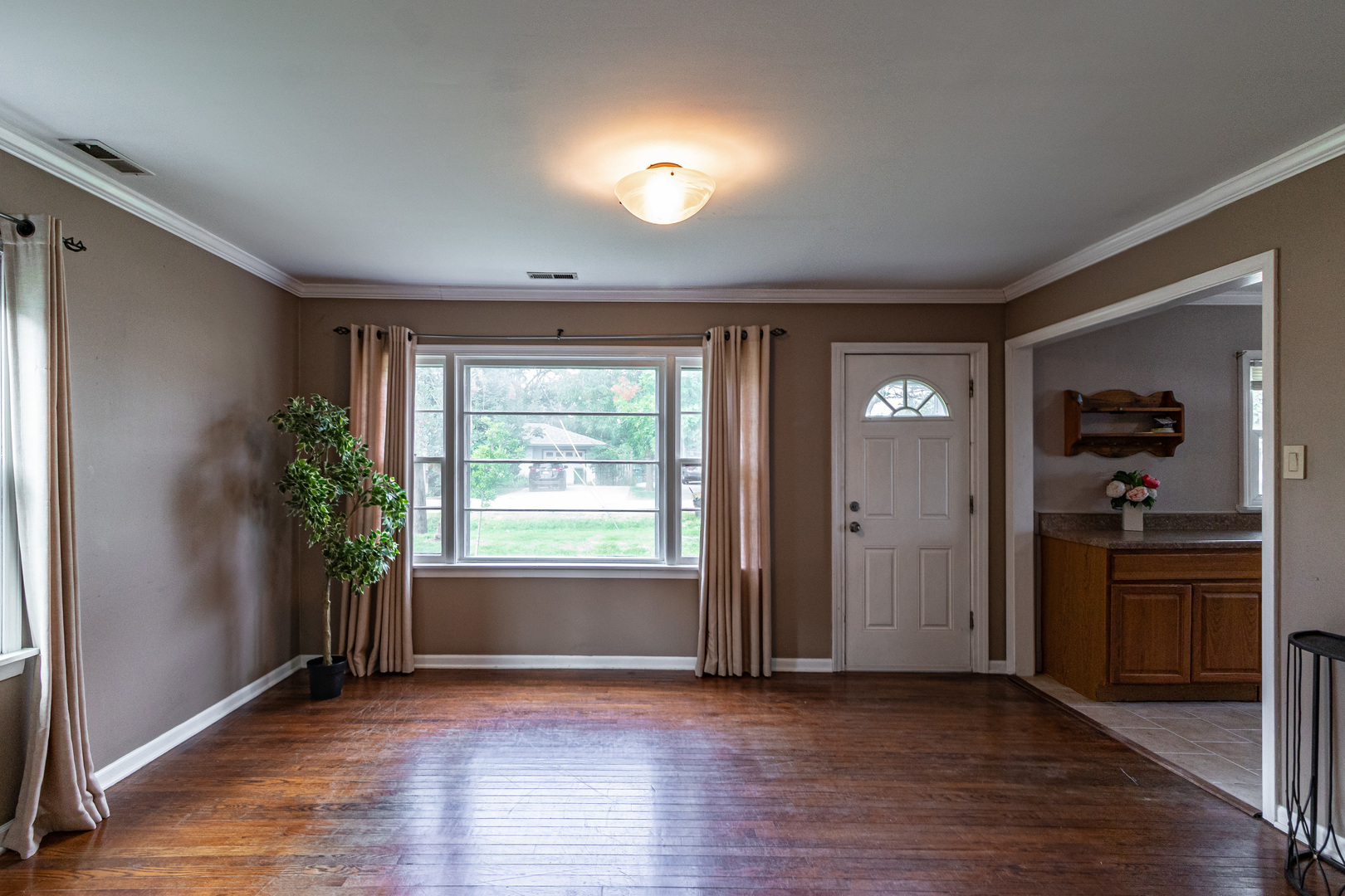 18229 West Big Oaks Road Grayslake, IL 60030 - Photo 4 of 22 an empty room with wooden floor and a window