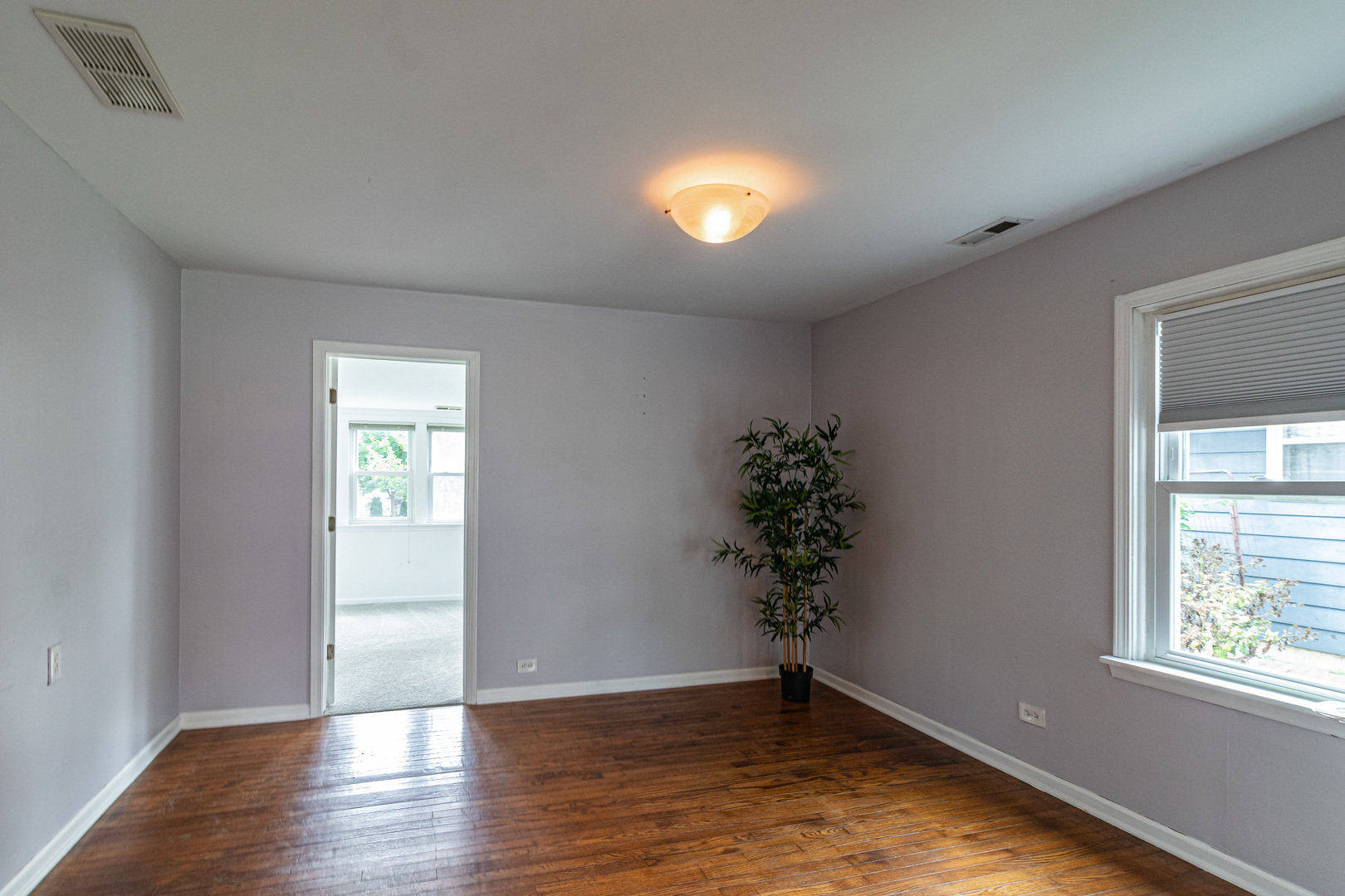 18229 West Big Oaks Road Grayslake, IL 60030 - Photo 6 of 22 an empty room with wooden floor and windows