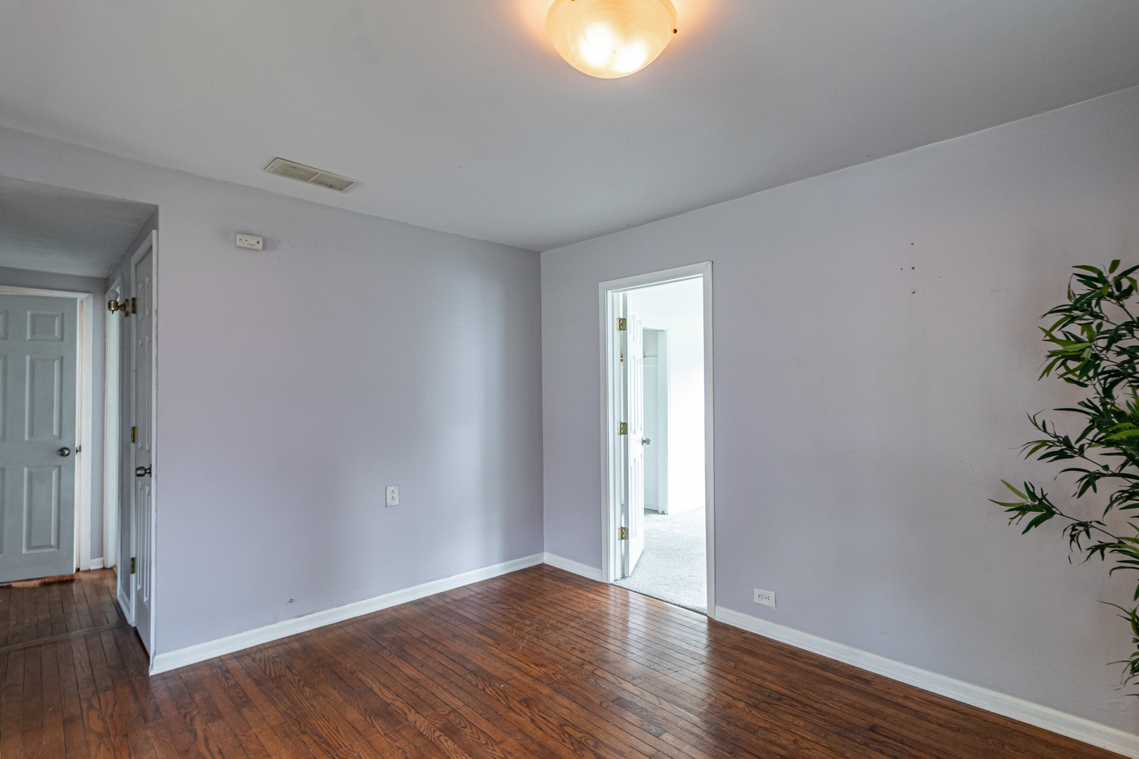 18229 West Big Oaks Road Grayslake, IL 60030 - Photo 7 of 22 a view of an empty room with wooden floor and a window