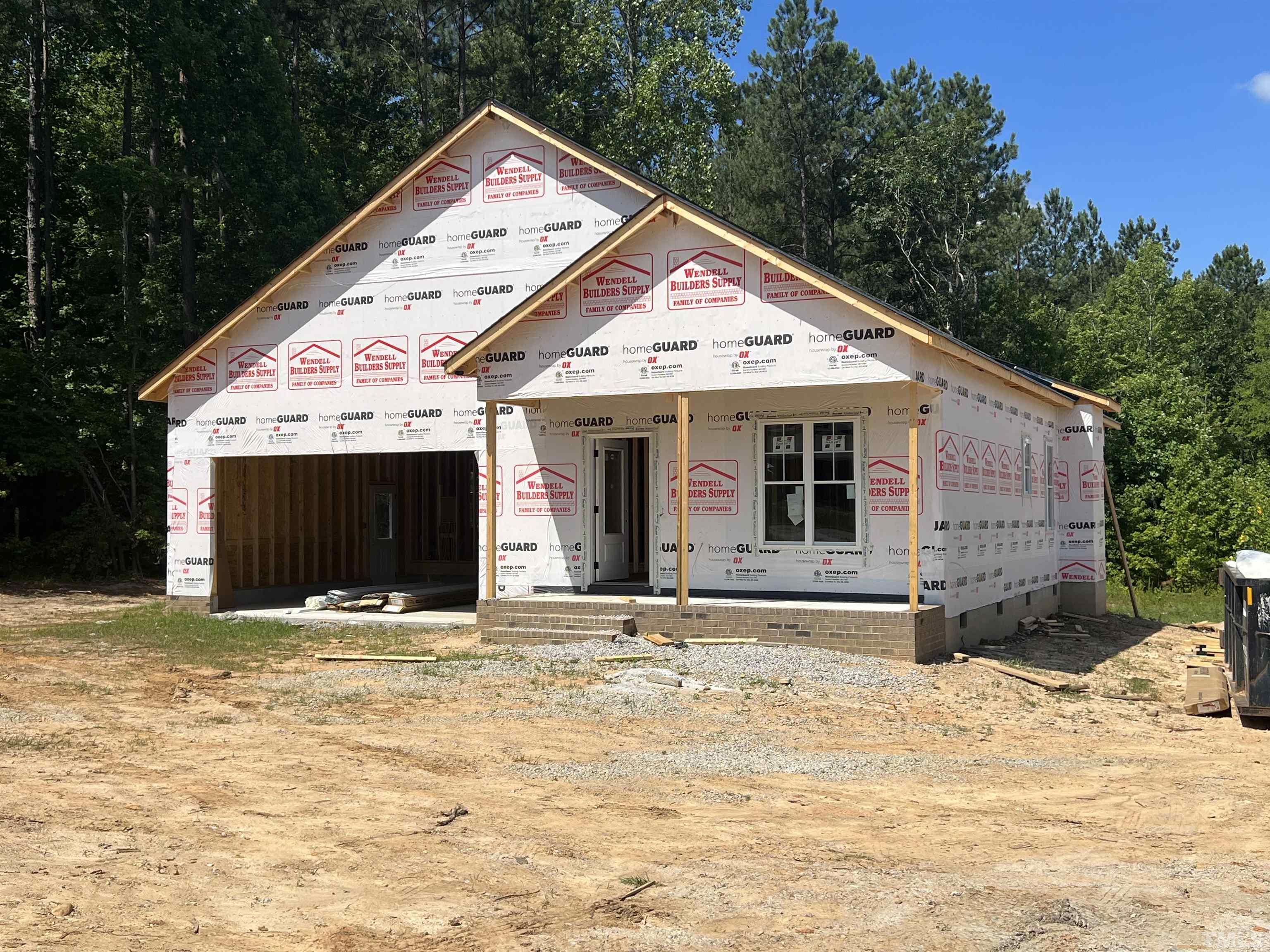 4596 Debnam Road Zebulon, NC 27597 - Photo 1 of 8 a view of a house with a yard and garage