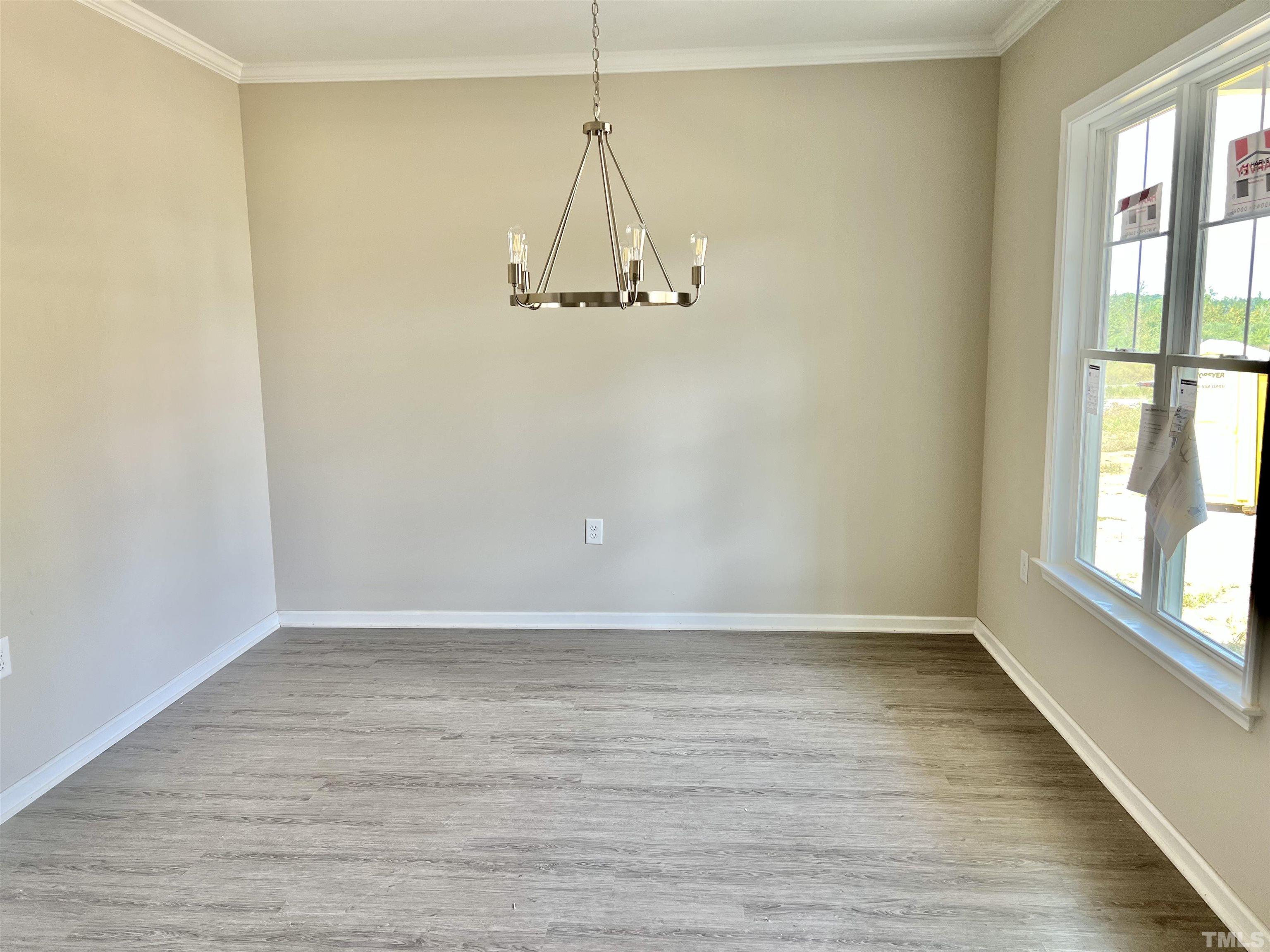 4596 Debnam Road Zebulon, NC 27597 - Photo 8 of 8 a room with a window and wooden floor