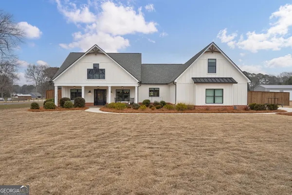 an aerial view of a house with a yard