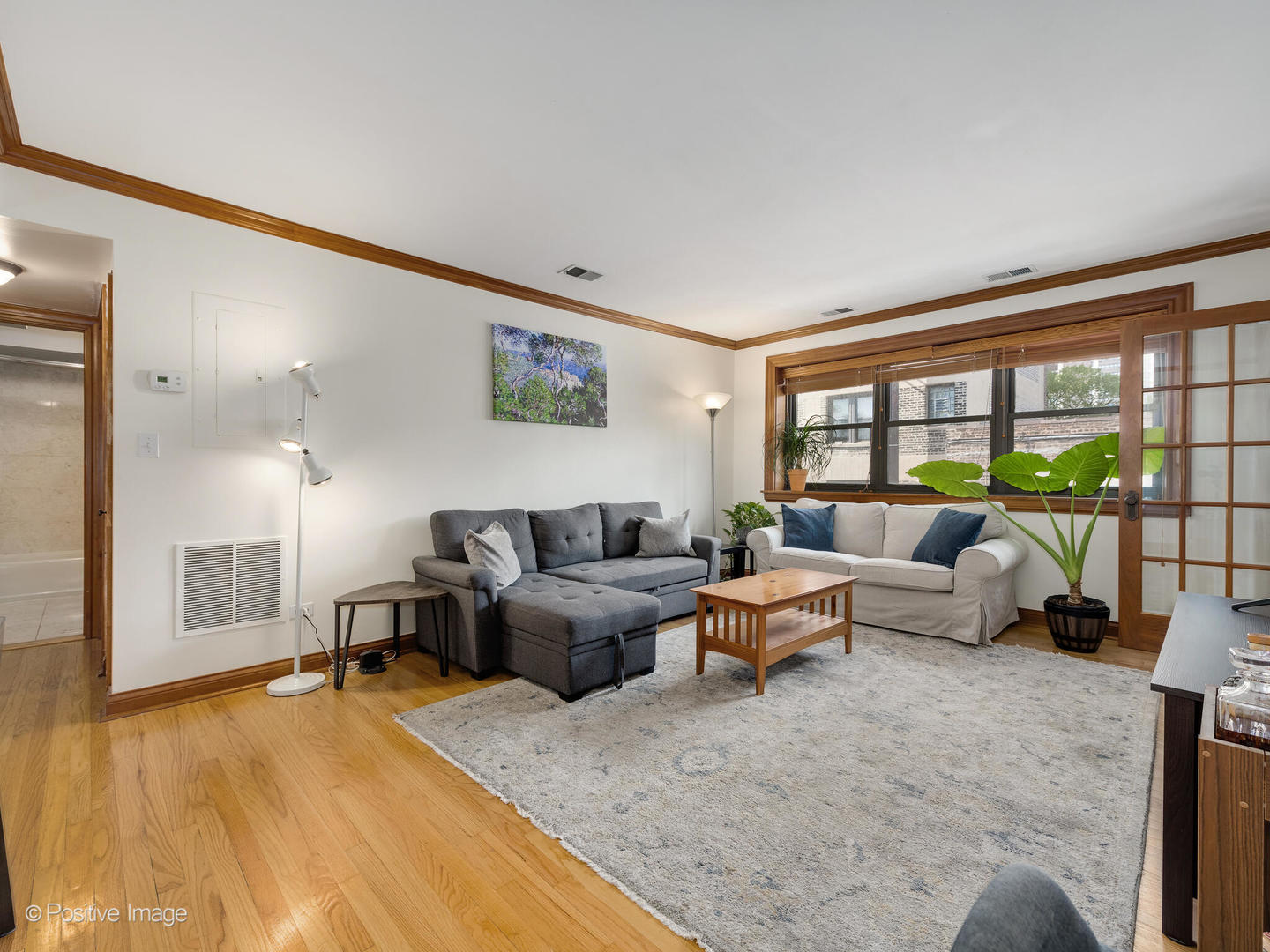 512 West Barry Avenue, Unit 312 Chicago, IL 60657 - Photo 2 of 12 a living room with furniture large window and a table
