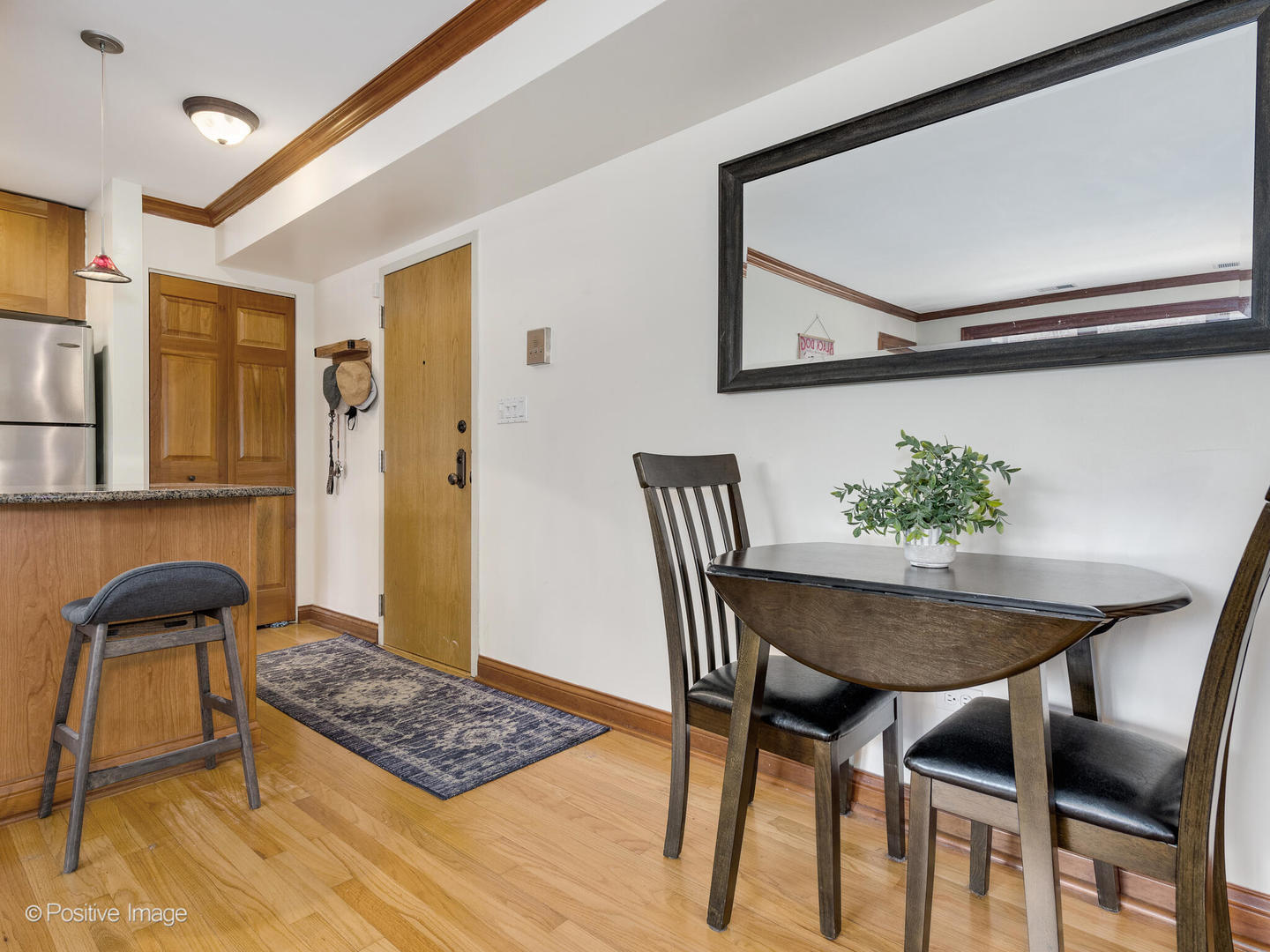 512 West Barry Avenue, Unit 312 Chicago, IL 60657 - Photo 4 of 12 a view of a dining room with furniture and wooden floor