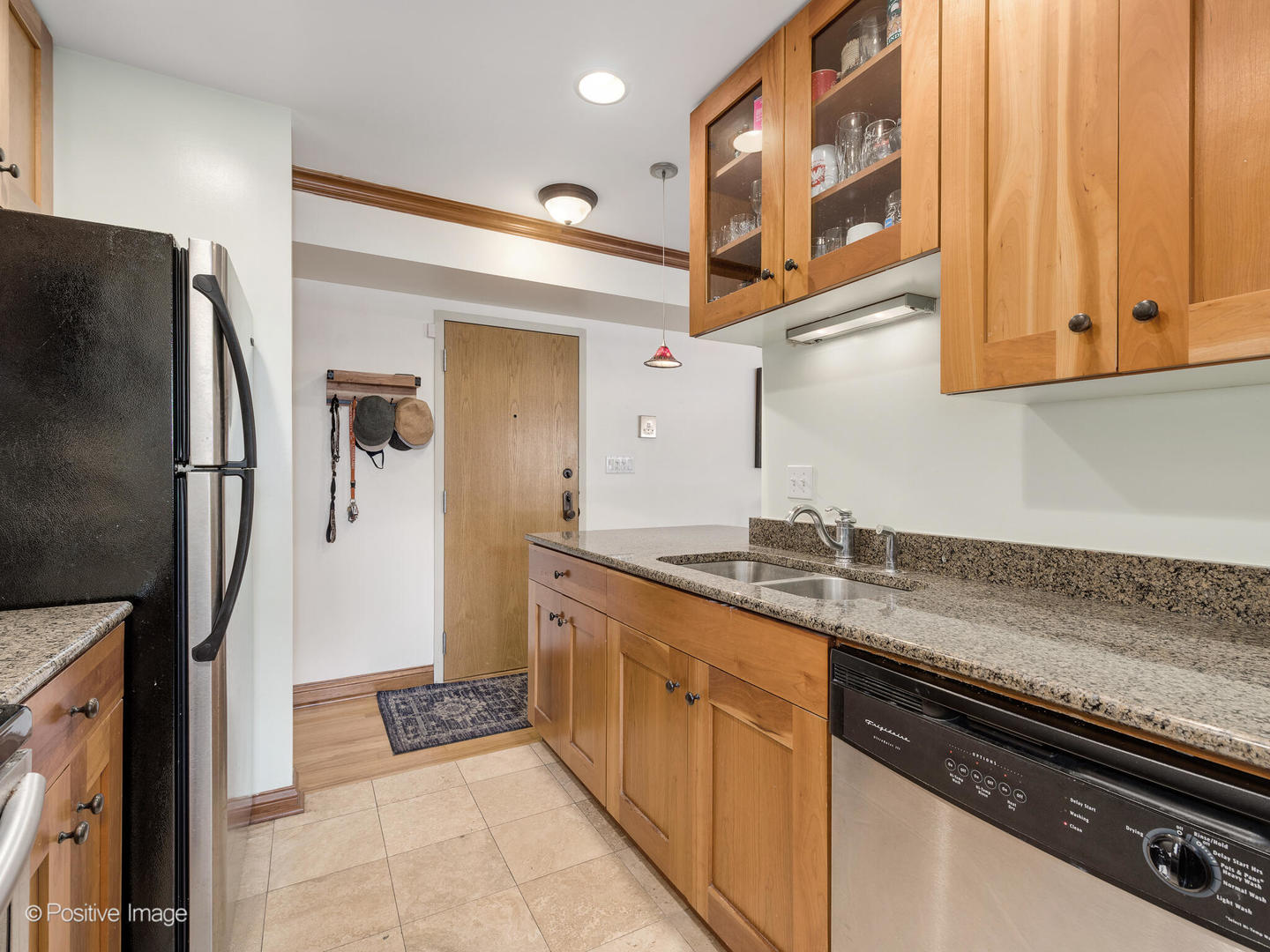 512 West Barry Avenue, Unit 312 Chicago, IL 60657 - Photo 8 of 12 a kitchen with stainless steel appliances granite countertop a refrigerator and a stove