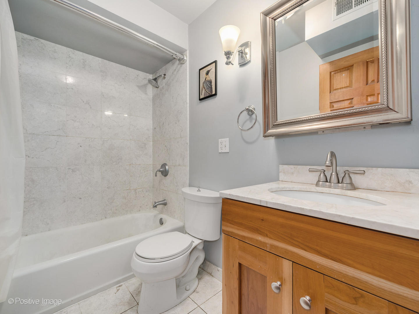 512 West Barry Avenue, Unit 312 Chicago, IL 60657 - Photo 10 of 12 a bathroom with a granite countertop sink toilet and shower