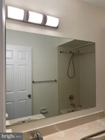 a bathroom with a shower and a sink
