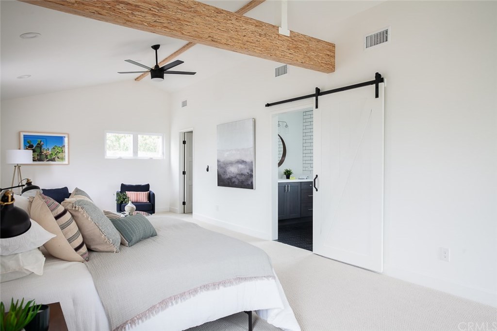 453 Broadway Costa Mesa, CA 92627 - Photo 19 of 39 a bedroom with a bed and a chandelier