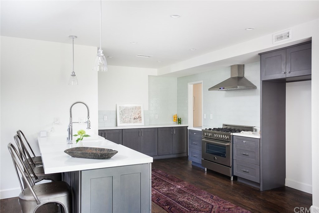 453 Broadway Costa Mesa, CA 92627 - Photo 8 of 39 a kitchen with a stove a table and chairs
