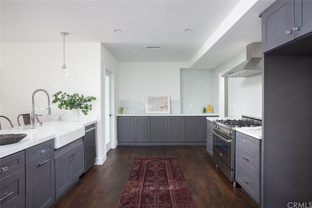 453 Broadway Costa Mesa, CA 92627 - Photo 10 of 39 a kitchen with stainless steel appliances granite countertop a sink stove and cabinets