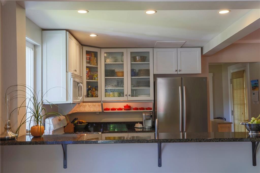 8 Pierce Street, Unit A Belfast, ME 04915 - Photo 12 of 34 Well-lit kitchen with dining area to...